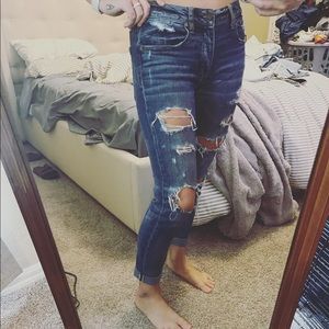 Tomgirl ripped jeans with cuffed bottoms.